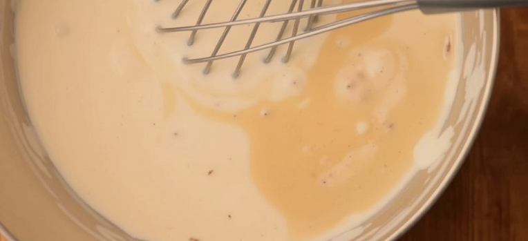 Creamy soup mixture being stirred in a bowl