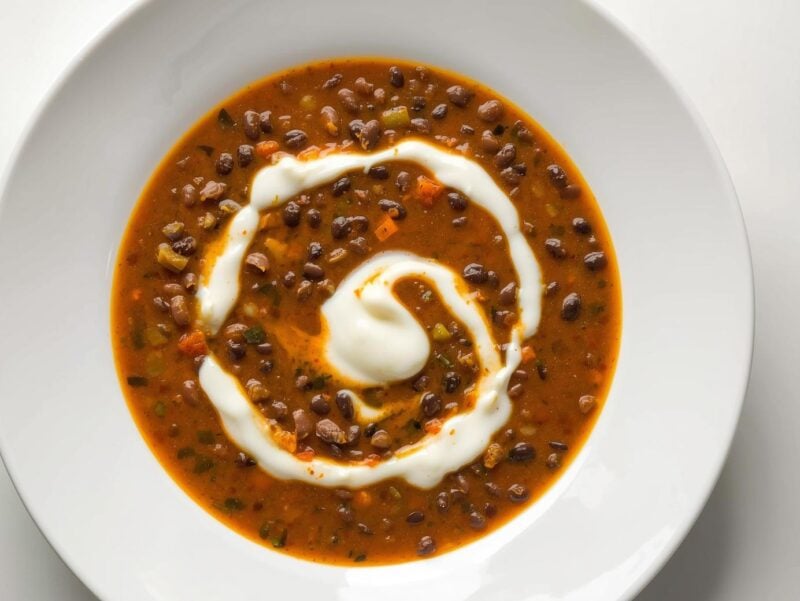 Dal Makhani with creamy black lentils garnished with cream, a popular vegetarian dish in 10 Indian curry recipes