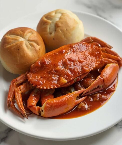 Singaporean chili crab in a rich, spicy sauce with mantou buns - one of the 15 Must-Try Asian Dishes