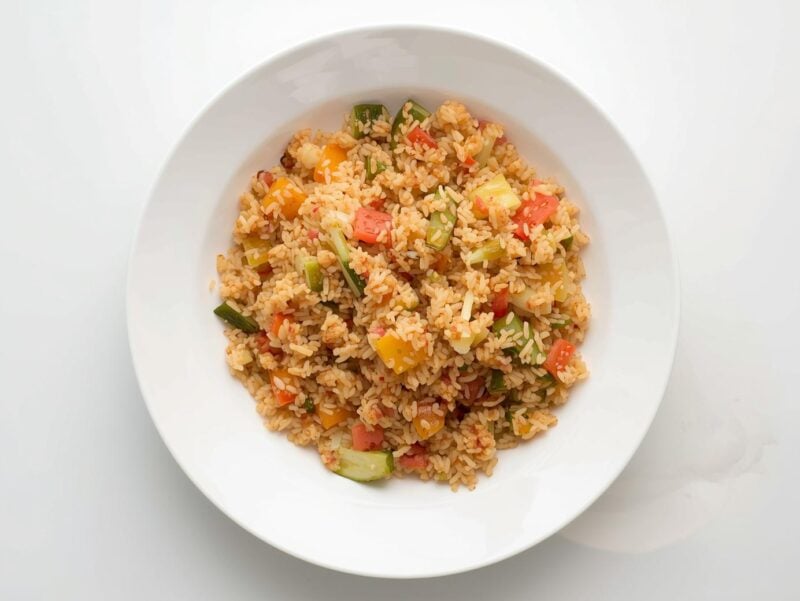 Step-by-step process of making Cauliflower Fried Rice in a wok