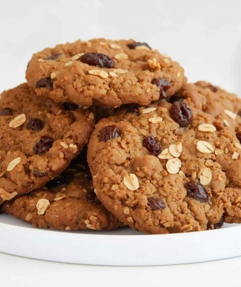 Vegan oatmeal raisin cookies stacked on a plate