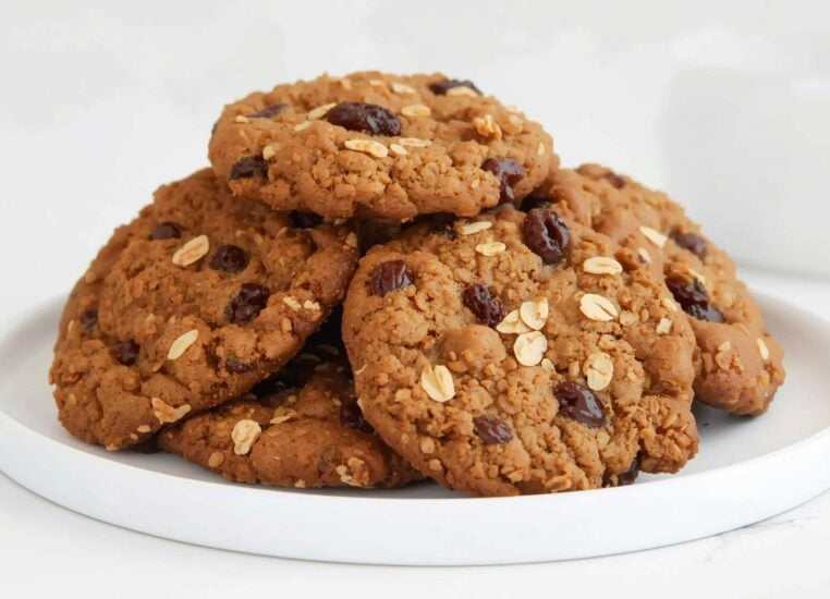 Vegan oatmeal raisin cookies stacked on a plate