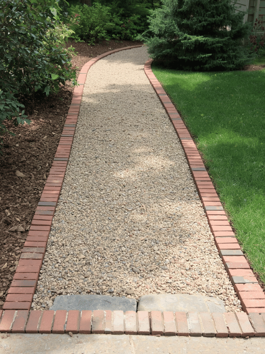 Edge a Gravel Walkway With Brick or Stone Keep a gravel path neat by adding a solid edge on both sides. Brick, natural stone, metal edging, or treated landscape timbers can prevent the gravel from spreading into nearby beds. A firm edge also makes sweeping and raking the path easier. Rating: ★★★★★ - Improves both appearance and long-term maintenance.